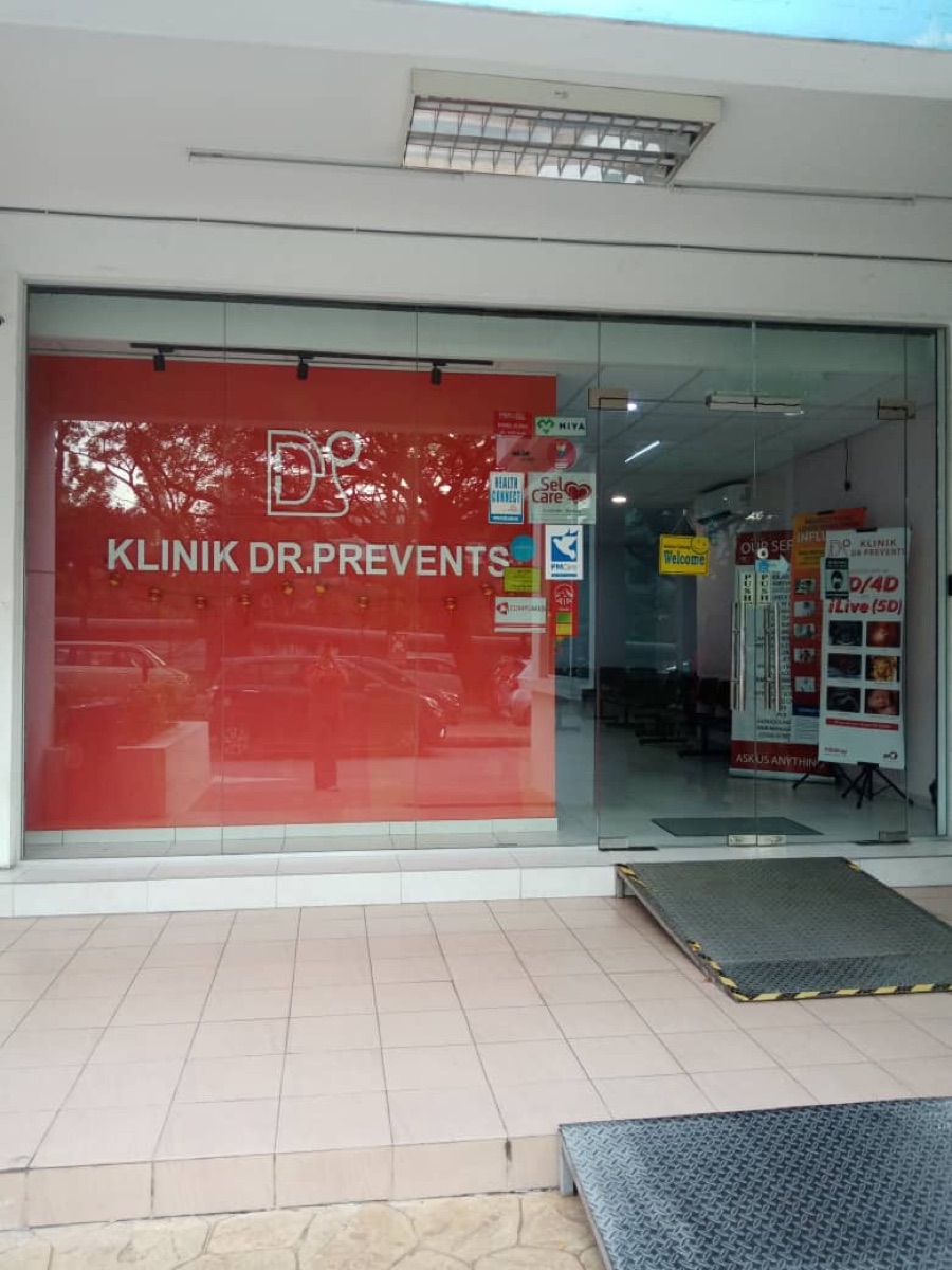 Glass entrance of Klinik Dr. Prevents Bandar Sri Damansara with the red logo wall